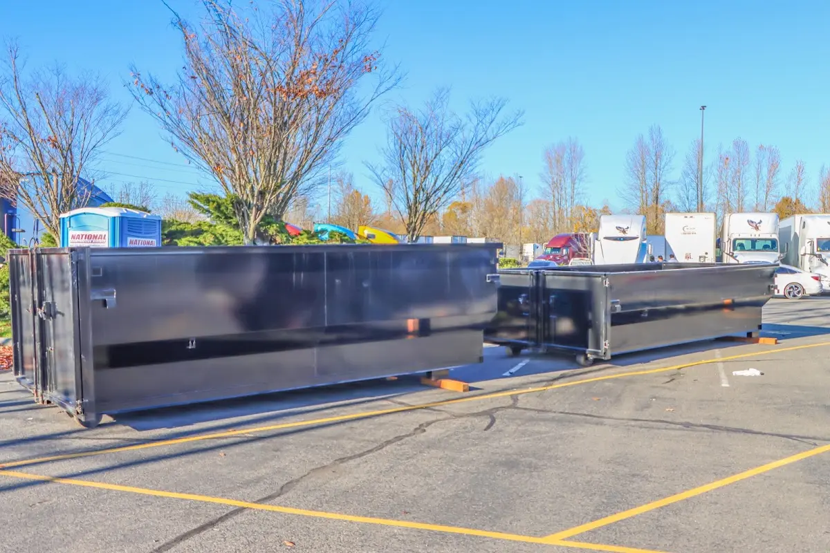 Professional dumpster rental service with roll-off container on residential driveway in Mundy